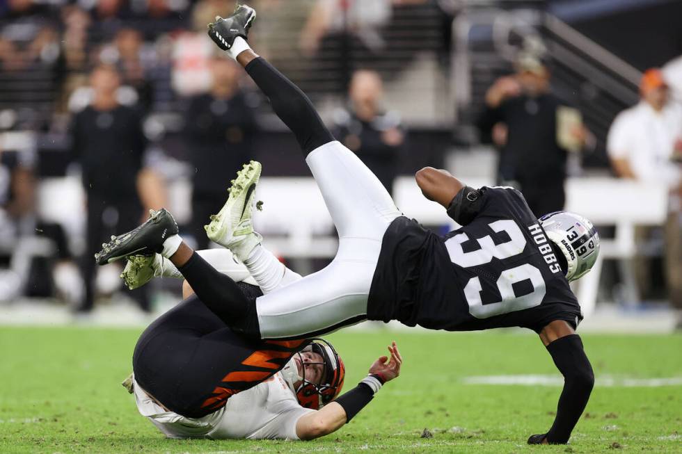 Raiders cornerback Nate Hobbs (39) tackles Cincinnati Bengals quarterback Joe Burrow (9) after ...