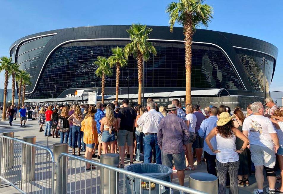Attendees for a Garth Brooks concert line up at Allegiant Stadium about two hours before the ev ...