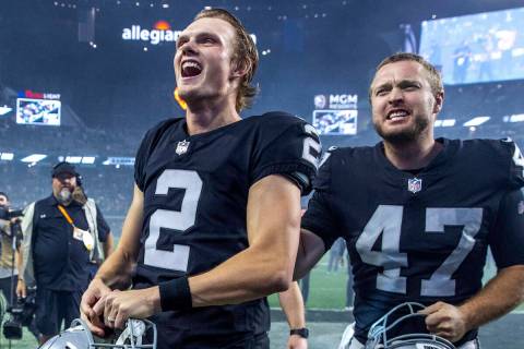 Raiders kicker Daniel Carlson (2) happily runs off the field with teammate long snapper Trent S ...