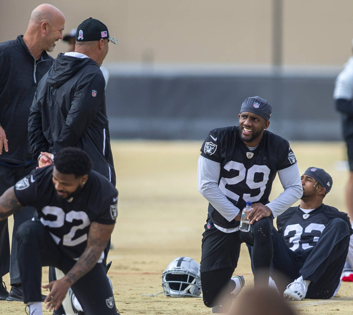 Raiders cornerback Casey Hayward (29) meets with Raiders defensive coordinator Gus Bradley, lef ...