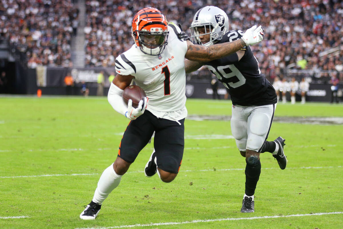 Raiders cornerback Casey Hayward (29) pushes Cincinnati Bengals wide receiver Ja'Marr Chase (1) ...