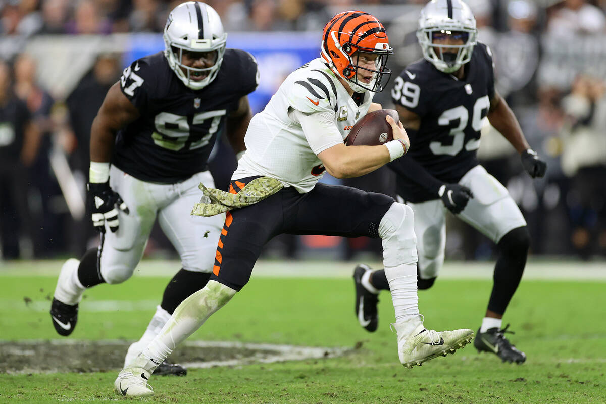 Cincinnati Bengals quarterback Joe Burrow (9) runs the ball against Raiders defensive tackle Da ...