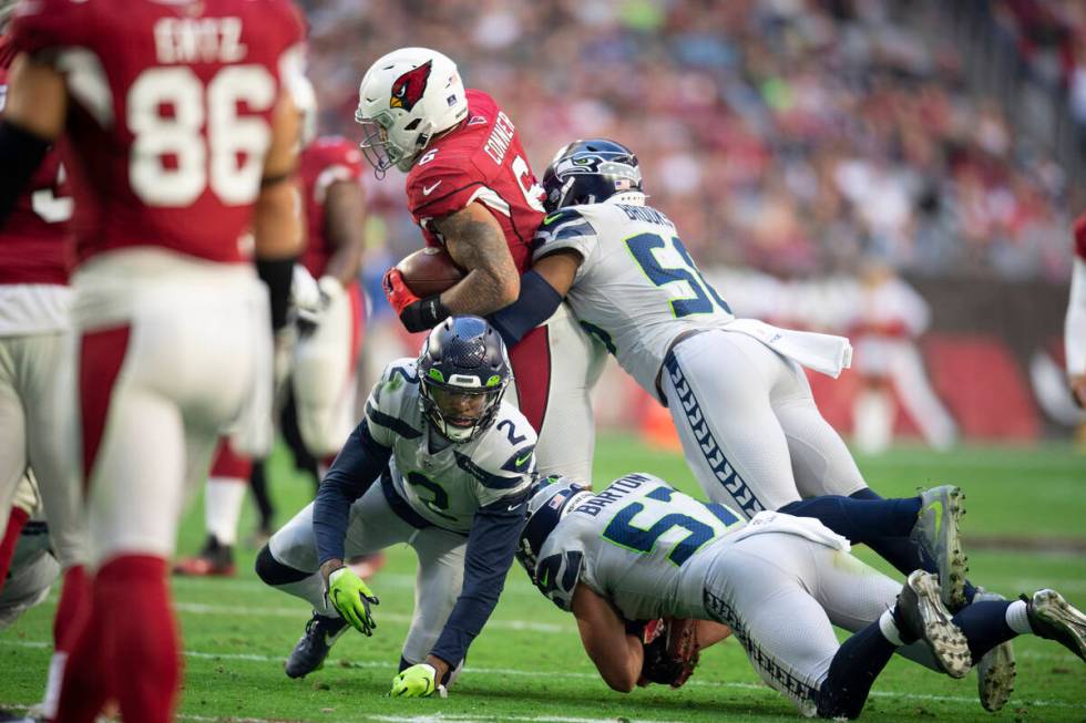 Arizona Cardinals running back James Conner (6) is tackled by Seattle Seahawks cornerback D.J. ...