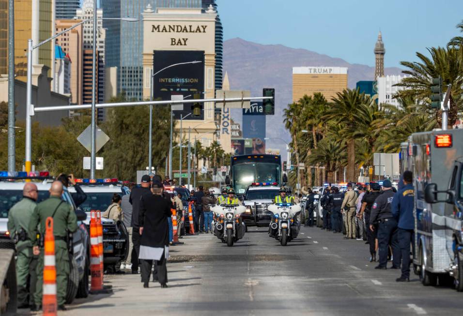 Busses with Raiders players, coaches and personnel are escorted by Metro to depart the city as ...