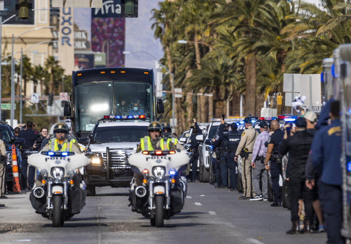 Busses with Raiders players, coaches and personnel are escorted by Metro to depart the city as ...