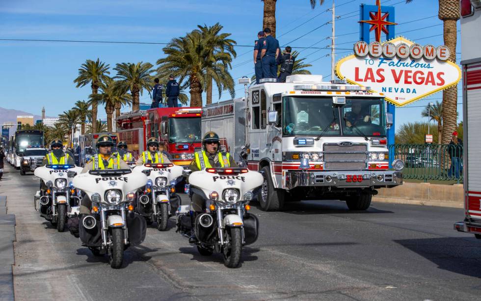 Busses with Raiders players, coaches and personnel are escorted by Metro to depart the city as ...