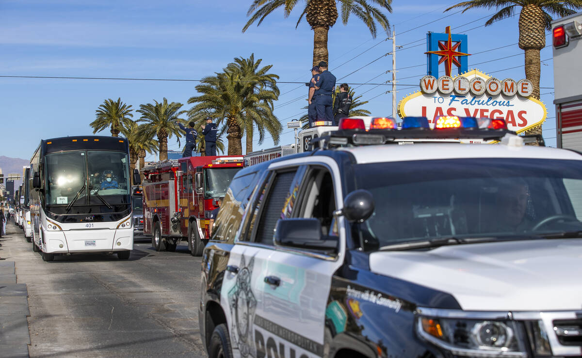 Busses with Raiders players, coaches and personnel are escorted by Metro to depart the city as ...