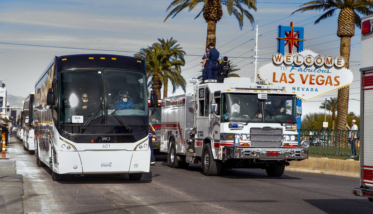 Busses with Raiders players, coaches and personnel are escorted by Metro to depart the city as ...