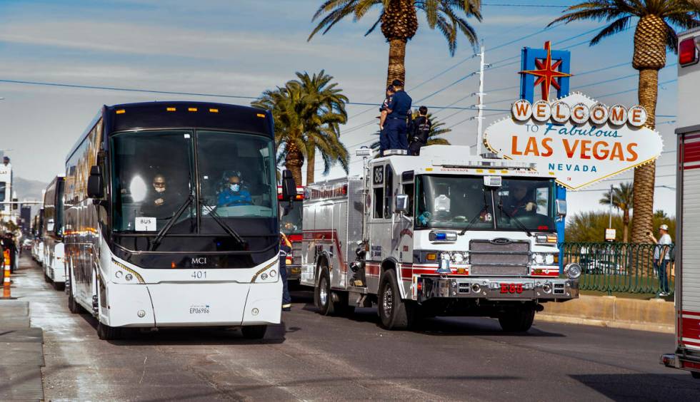 Busses with Raiders players, coaches and personnel are escorted by Metro to depart the city as ...