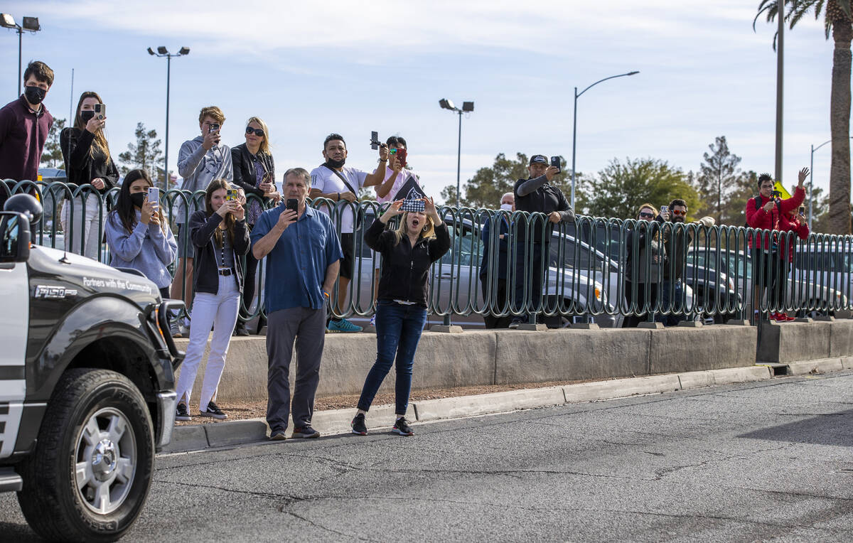 Busses with Raiders players, coaches and personnel are escorted by Metro to depart the city as ...