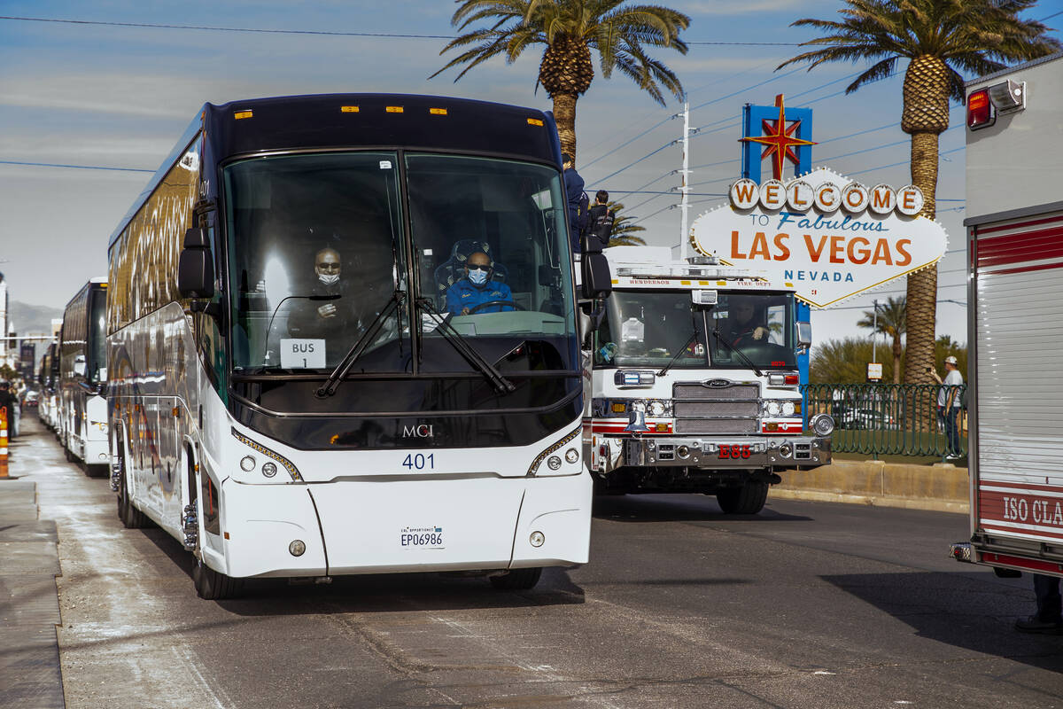 Busses with Raiders players, coaches and personnel are escorted by Metro to depart the city as ...