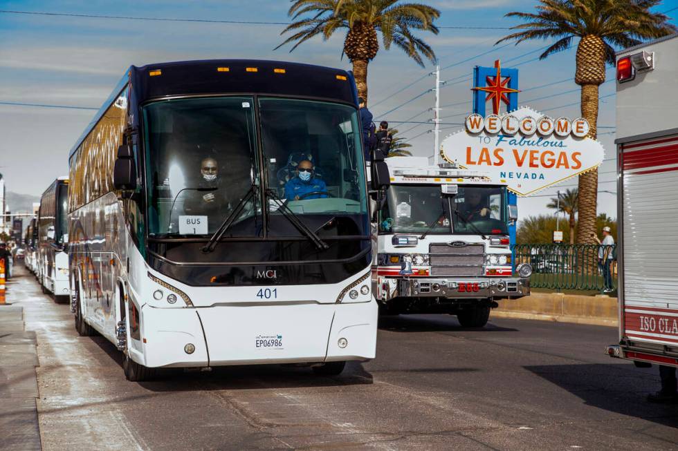 Busses with Raiders players, coaches and personnel are escorted by Metro to depart the city as ...