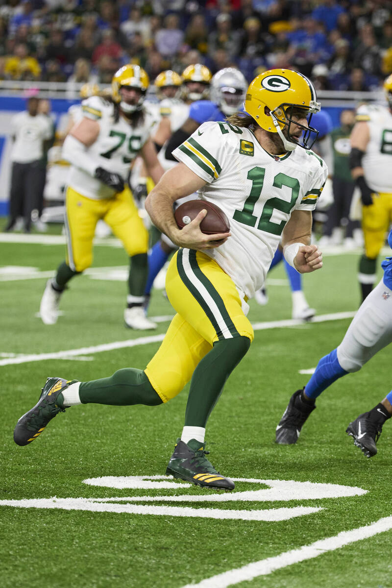 Green Bay Packers quarterback Aaron Rodgers (12) scrambles against the Detroit Lions during an ...