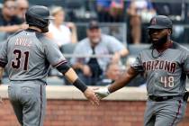 Arizona Diamondbacks' Alex Avila (31) celebrates with Abraham Almonte (48) after scoring off a ...