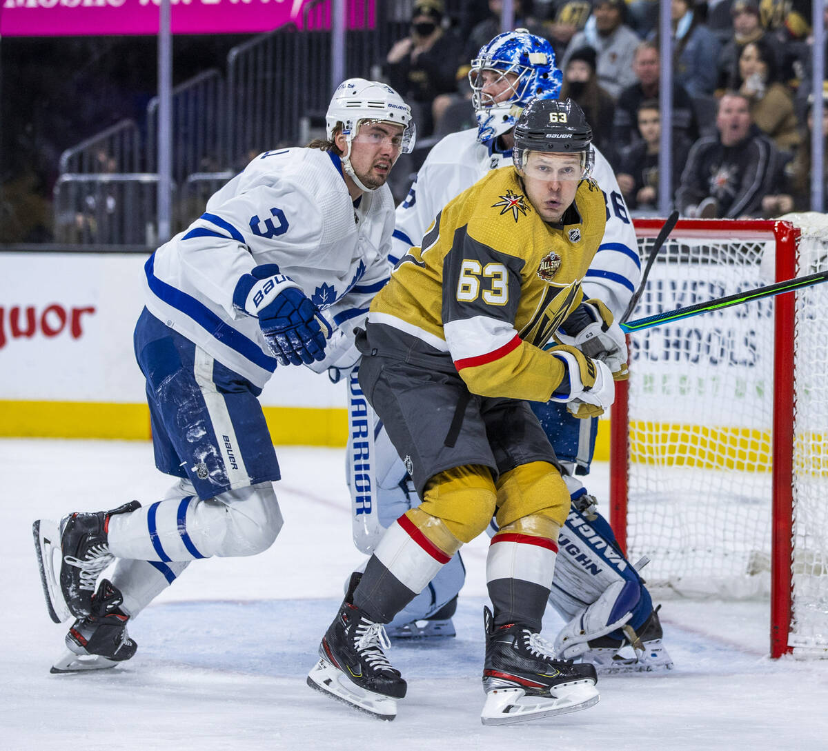 Golden Knights right wing Evgenii Dadonov (63) fights for position near the net with Toronto Ma ...