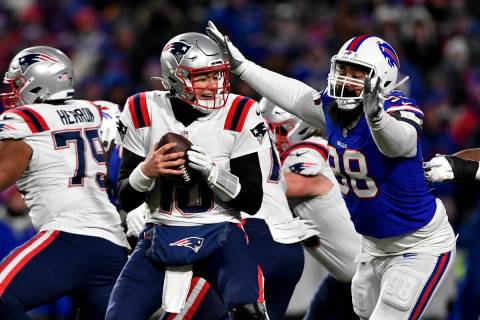 New England Patriots quarterback Mac Jones (10) is sacked by Buffalo Bills defensive tackle Sta ...