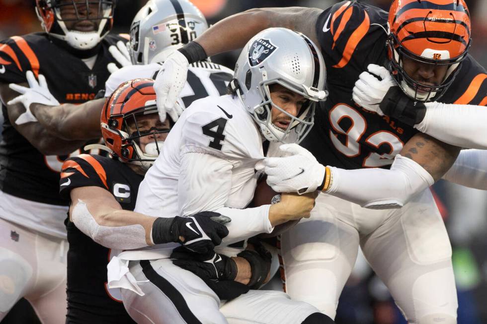 Raiders quarterback Derek Carr (4) is sacked at the goal line by Cincinnati Bengals defensive e ...