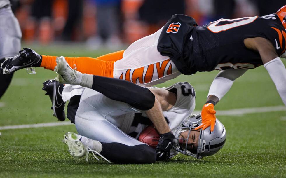 Raiders wide receiver Hunter Renfrow (13) recovers a muffed punt after being hit by Cincinnati ...