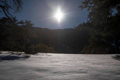 The sun shines on new snow along Upper Bristlecone Trail at Lee Canyon on Friday, Dec. 17, 2021 ...