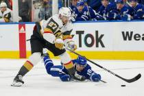 Vegas Golden Knights defenseman Shea Theodore (27) loses the puck after a diving poke-check by ...