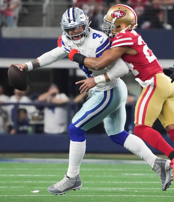 Dallas Cowboys quarterback Dak Prescott (4) is wrapped up by San Francisco 49ers defensive back ...