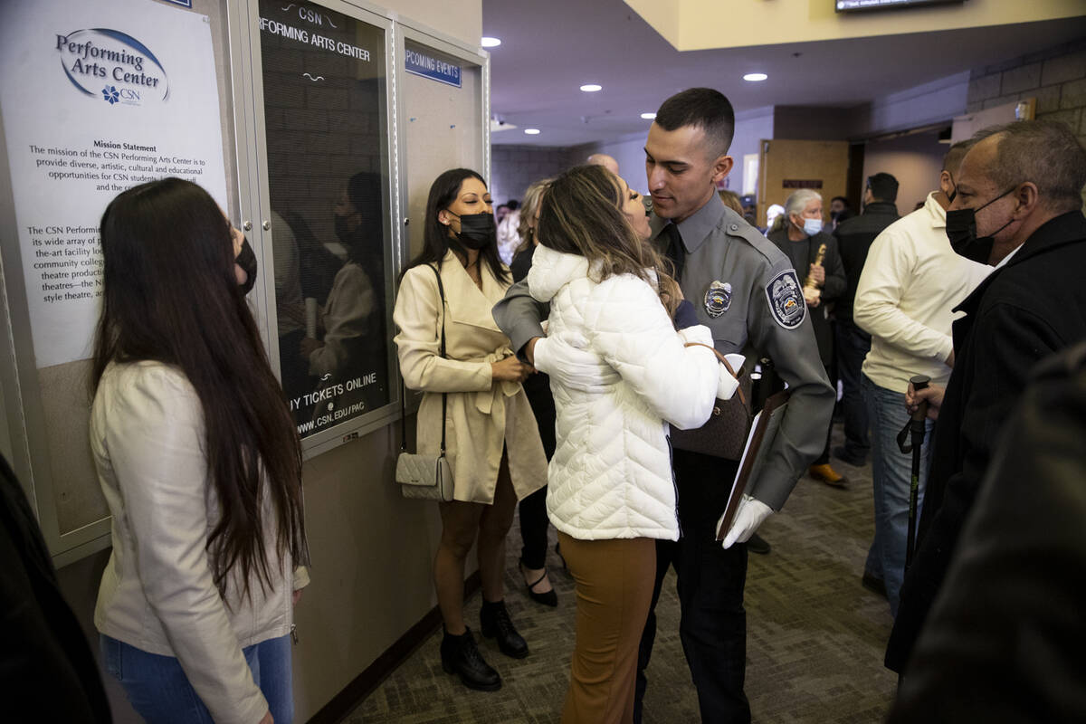 Academy graduate Carlos Morales, right, embraces his wife Tiffany Casales, following the Southe ...