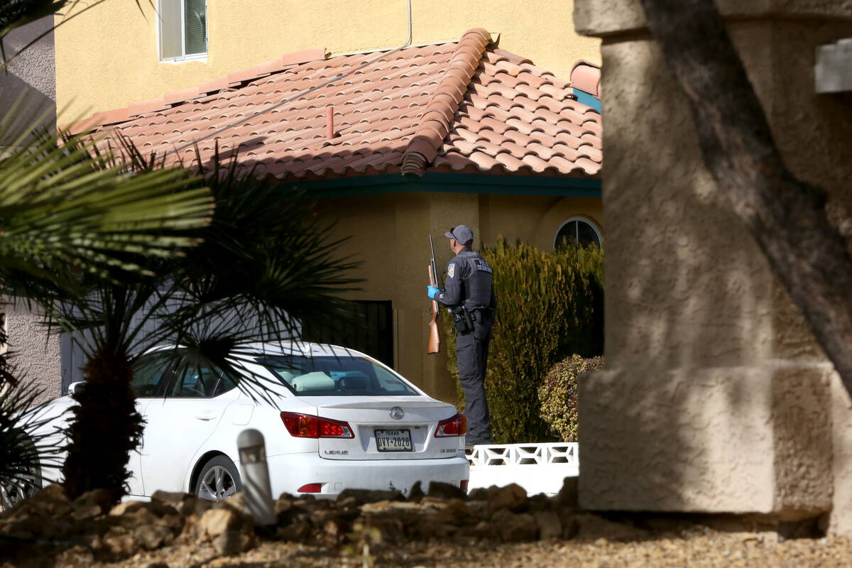 A game warden from the Nevada Department of Wildlife prepares to enter the backyard of a Las Ve ...