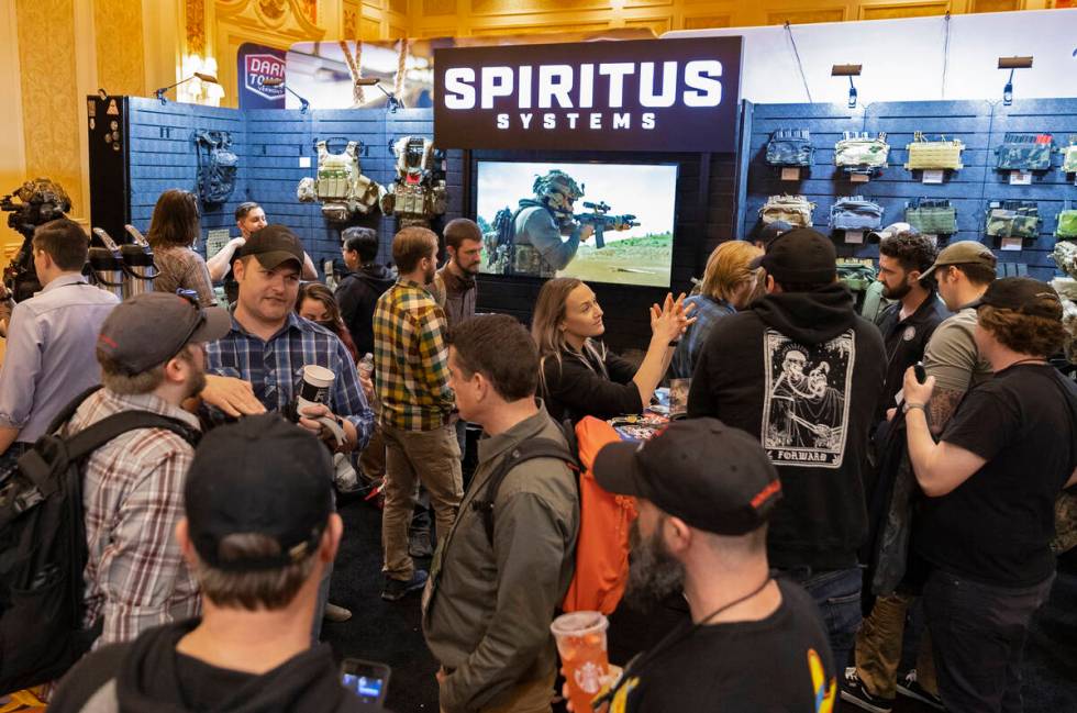 Attendees congregate at Spiritus Systems during the SHOT Show shooting, hunting and outdoor tra ...