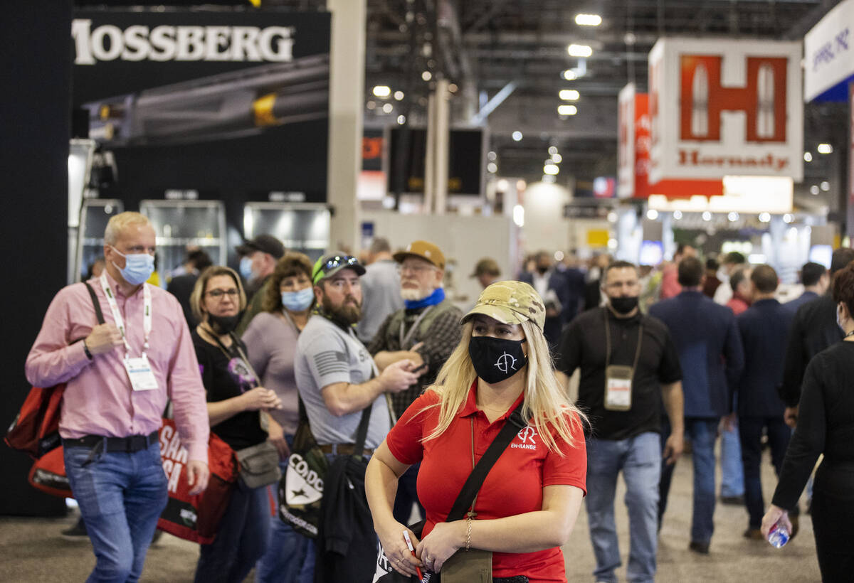 Attendees walk the convention halls during the SHOT Show shooting, hunting and outdoor trade sh ...