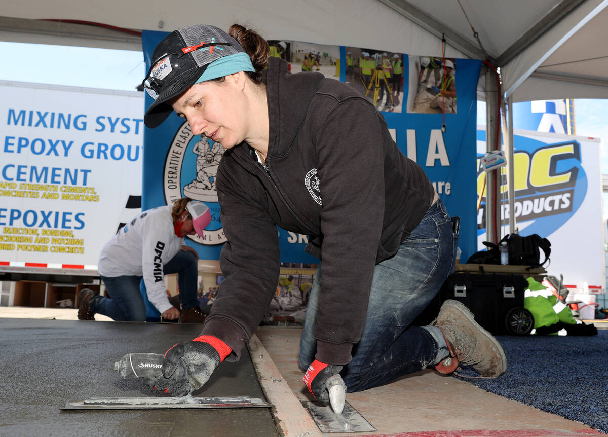 Liz Nichols of Portland, Ore. smooths a concrete slab in the Operative Plasterers’ and C ...