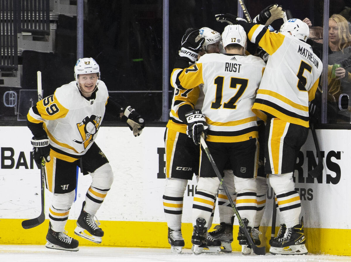 Penguins left wing Jake Guentzel (59) celebrates with teammates after Pittsburgh scored a third ...