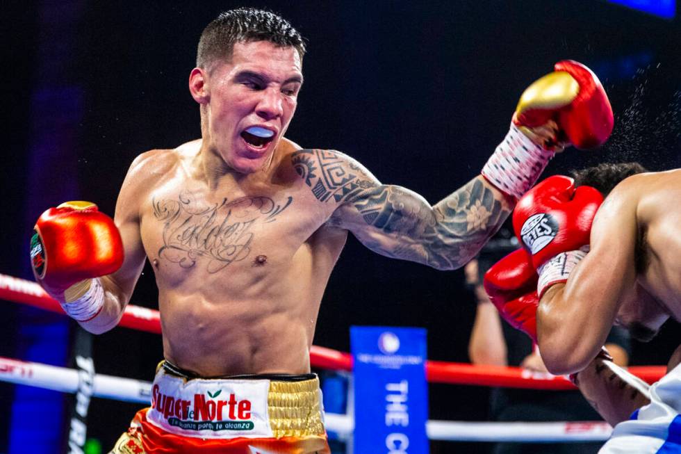 Oscar Valdez, left, readies to strike Adam Lopez again during round 6 of their WBC super feathe ...