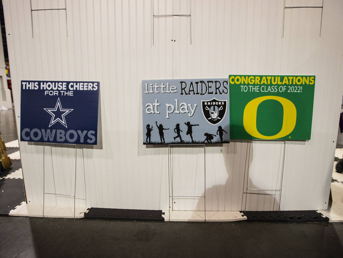 Front yard signs are seen at the Fan Creations booth during the Sports Licensing & Tailgate ...