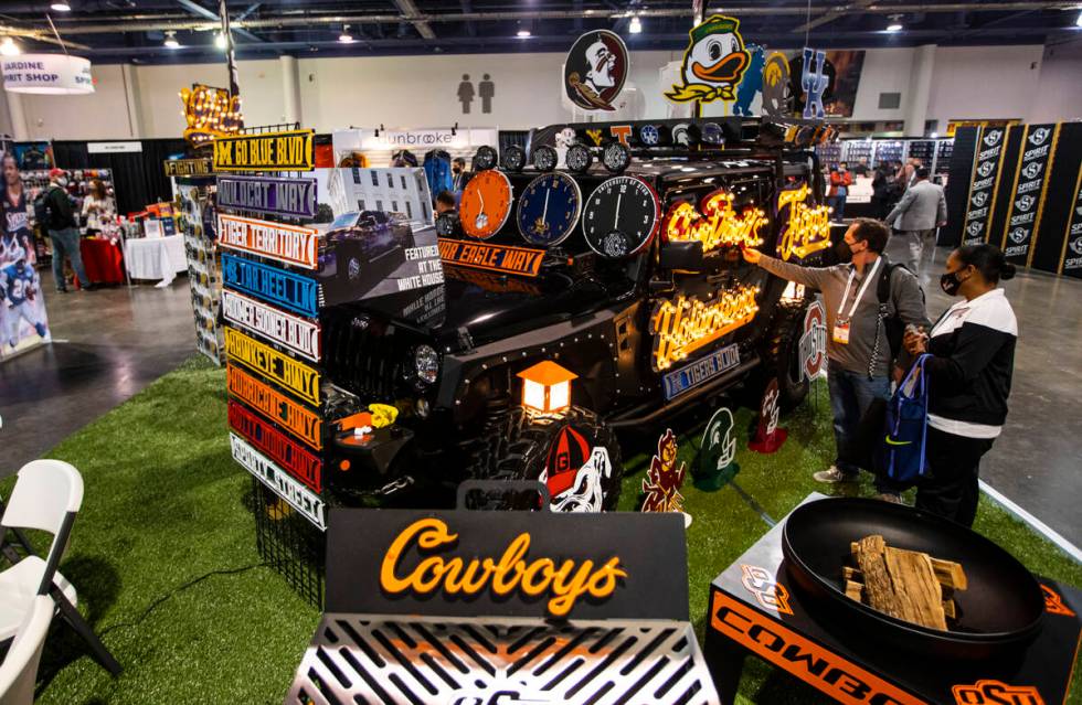 Ken Adelson, of Scottsdale, Ariz., checks out a sign at the Gameday Ironworks booth is seen dur ...