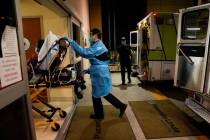 Emergency medical technician Thomas Hoang, 29, of Emergency Ambulance Service, pushes a gurney ...