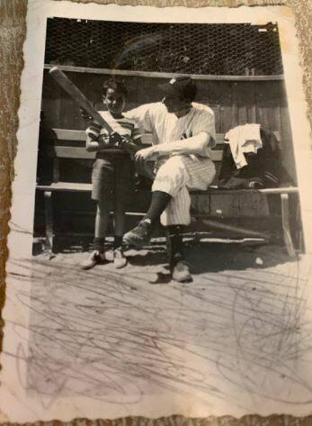 A young Hank Goldberg hangs out with former New York Yankees legend Joe DiMaggio at spring trai ...