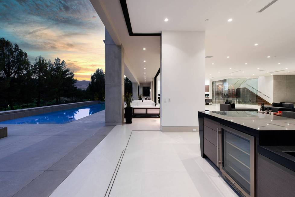 The home's kitchen leads to the pool area. (Unique Custom Homes)