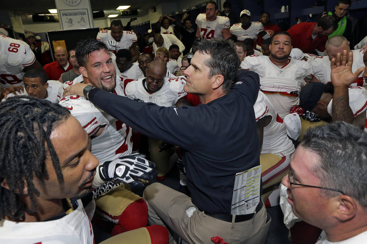 San Francisco 49ers head coach Jim Harbaugh celebrates with the team after the NFL football NFC ...