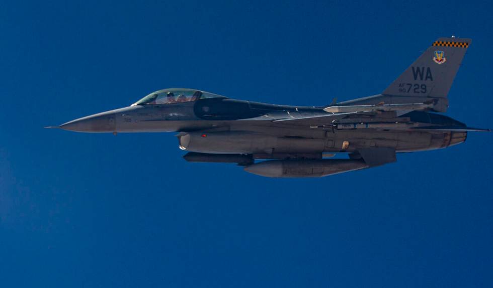 An F-16 flies alongside a KC-135 Stratotanker as it refuels planes around the Nevada Test and T ...