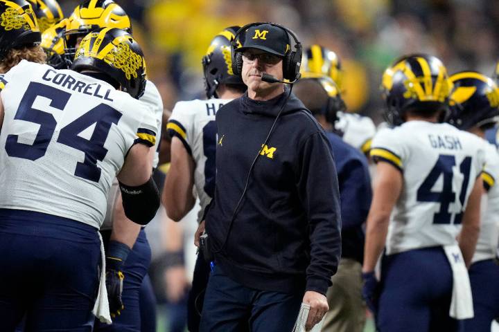 Michigan head coach Jim Harbaugh walks on the sideline during the first half of the Big Ten cha ...