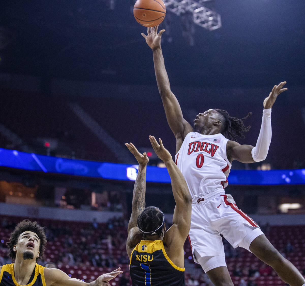 UNLV Rebels forward Victor Iwuakor (0) rolls off a shot over San Jose State Spartans guard Cale ...