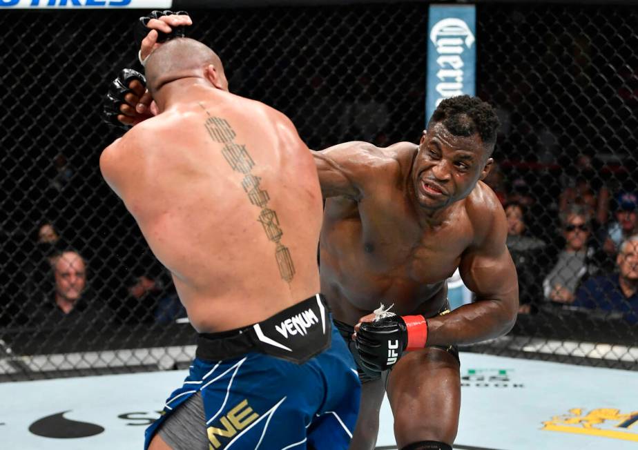Francis Ngannou, right, of Cameroon punches Ciryl Gane of France in their UFC heavyweight champ ...