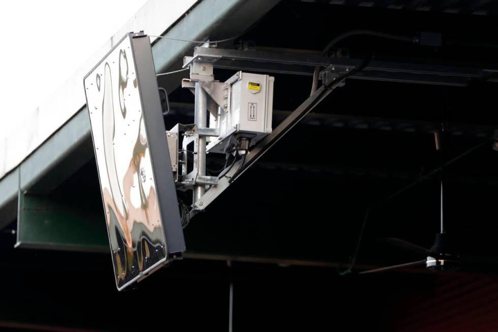 FILE - In this July 10, 2019, file photo, a radar device is seen on the roof behind home plate ...