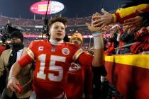 Kansas City Chiefs quarterback Patrick Mahomes (15) celebrates with fans as he walks off the fi ...