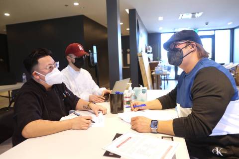 Charles Calderon of Las Vegas, right, applies for a sushi chef position with Executive Sous Che ...