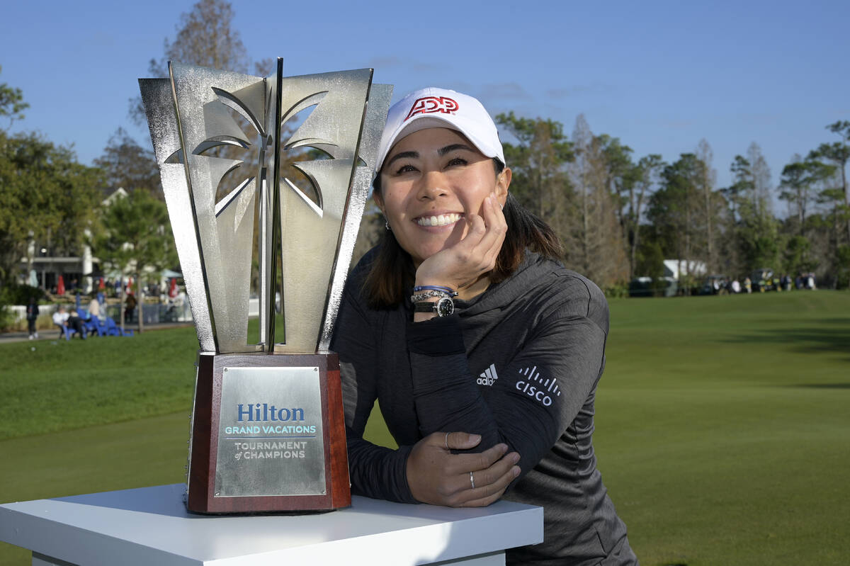 Danielle Kang poses next to the championship trophy on the 18th green after winning the Tournam ...