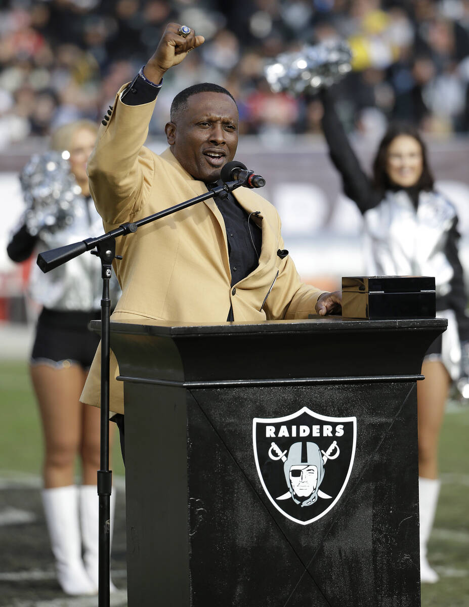 Former Oakland Raiders wide receiver Tim Brown gestures while speaking at a ceremony honoring h ...