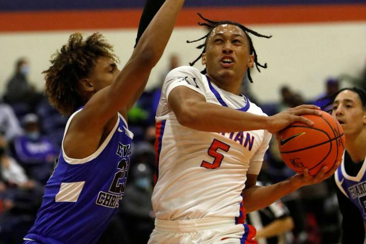 Bishop Gorman High School's Darrion Williams (5) shoots over Evangel Christian School's Christi ...