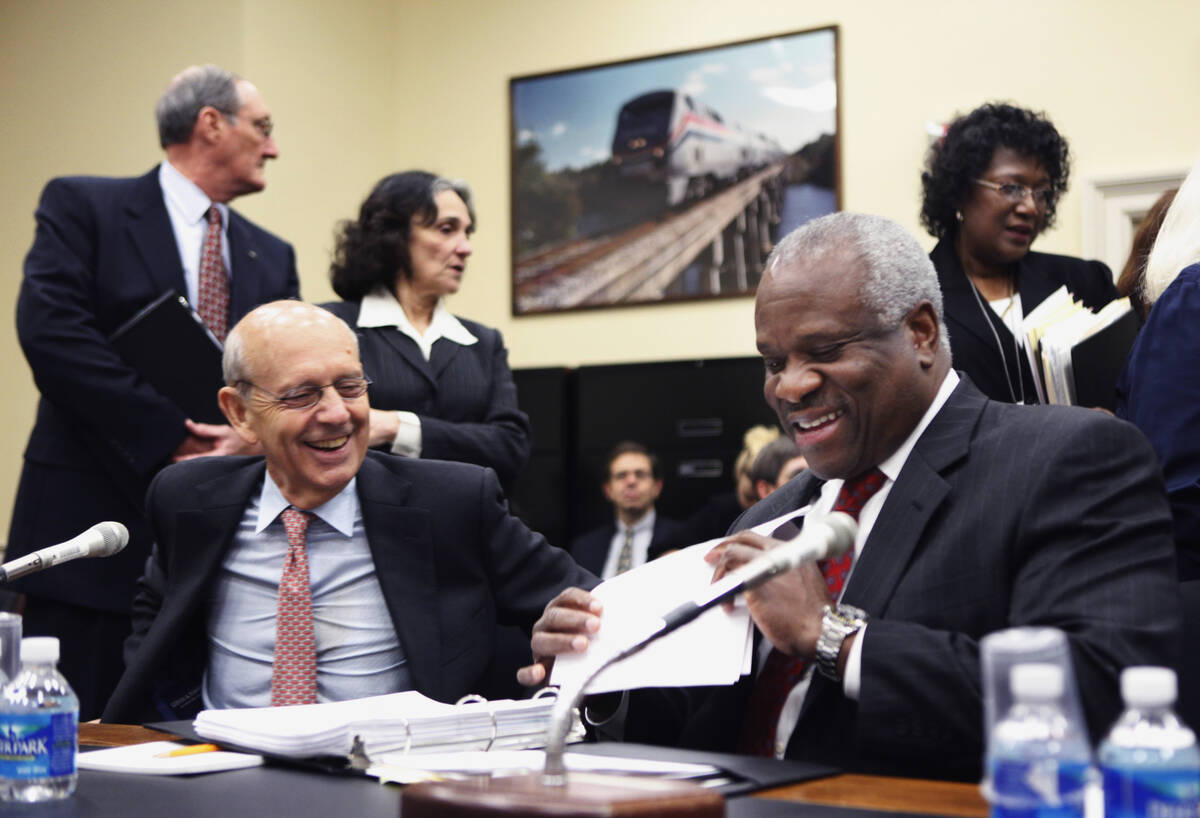 Supreme Court Associate Justices Stephen Breyer, left, and Clarence Thomas prepare to testify o ...