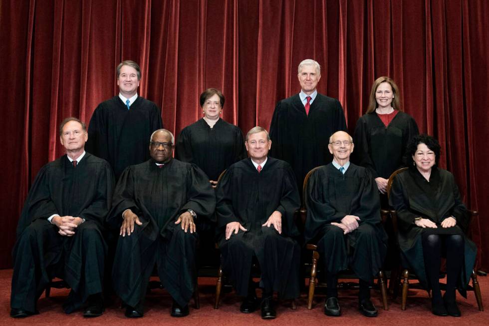 Members of the Supreme Court pose for a group photo at the Supreme Court in Washington, April 2 ...